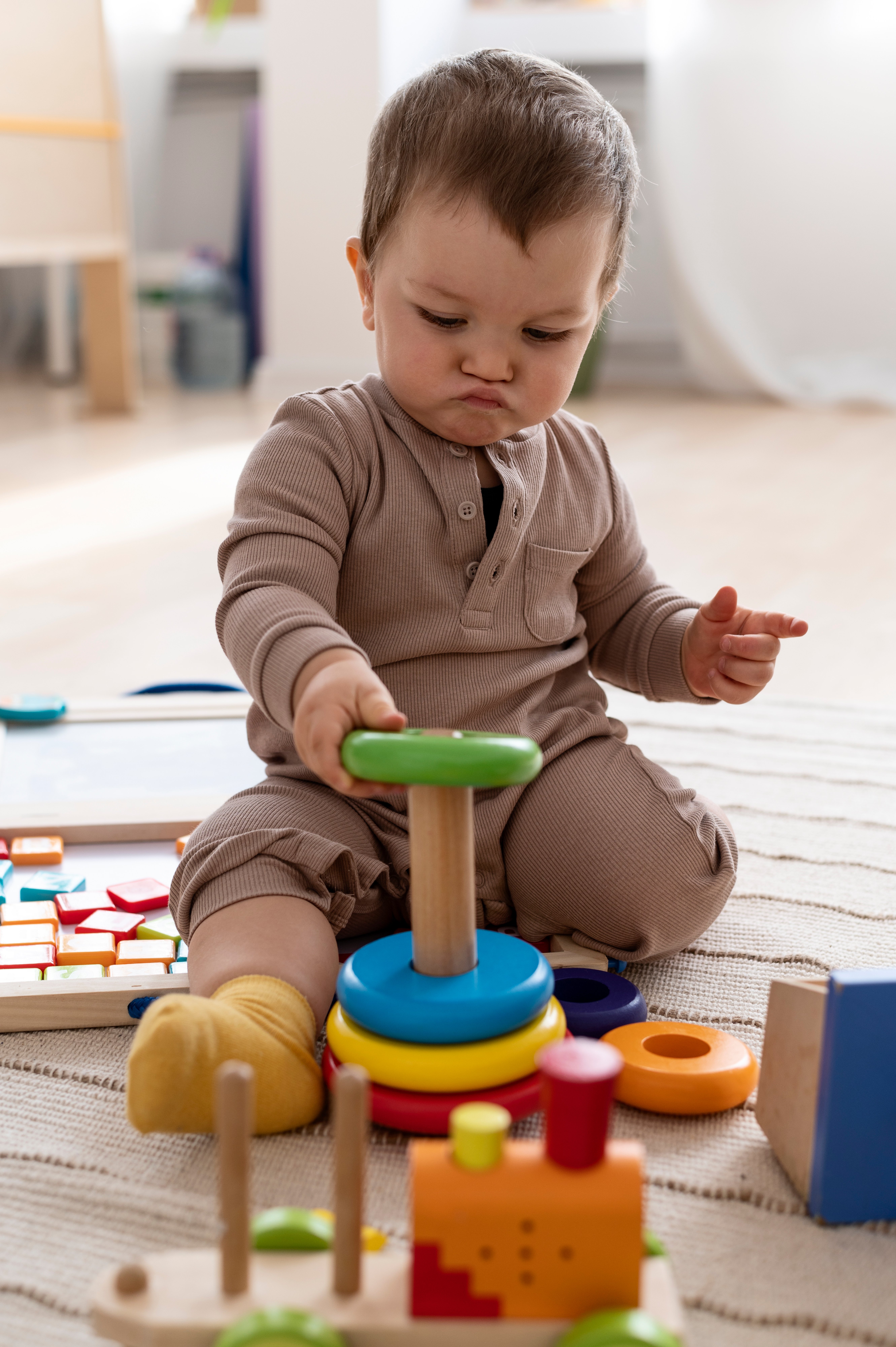 kid-playing-with-colorful-toys-full-shot